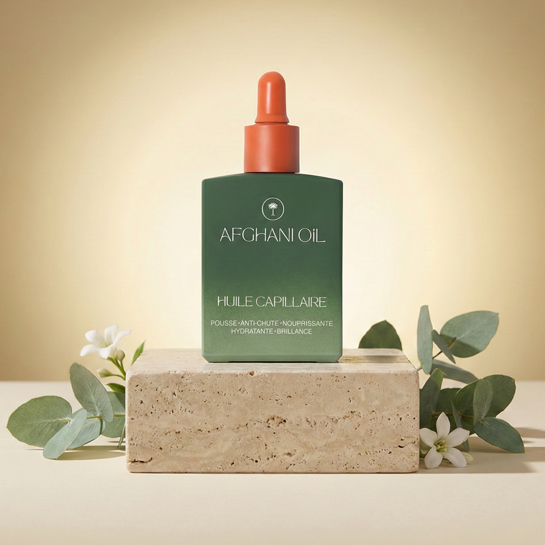 The Afghani Oil bottle on a travertine plinth against a deep green wall, lit by an arch of warm light with eucalyptus and white blossom