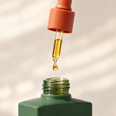 The terracotta dropper with a drop of oil at its tip