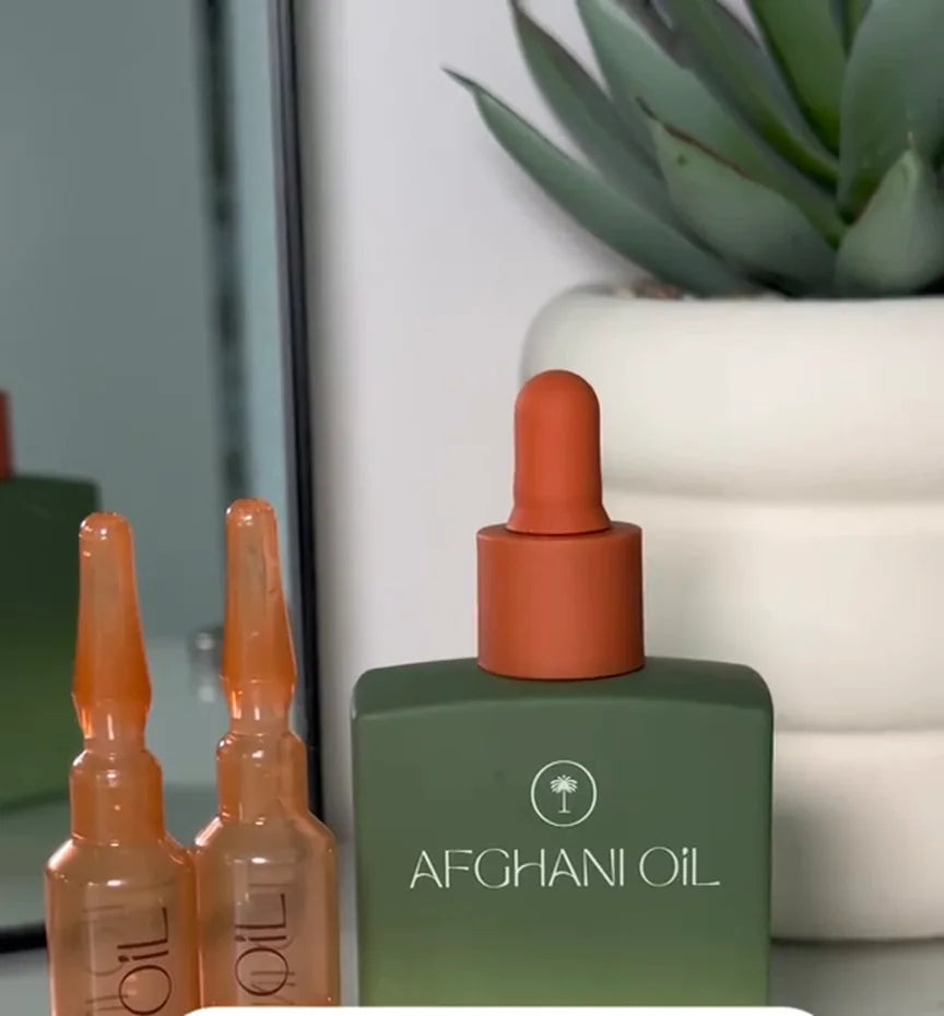Two Protocol ampoules standing beside the Afghani Oil bottle
