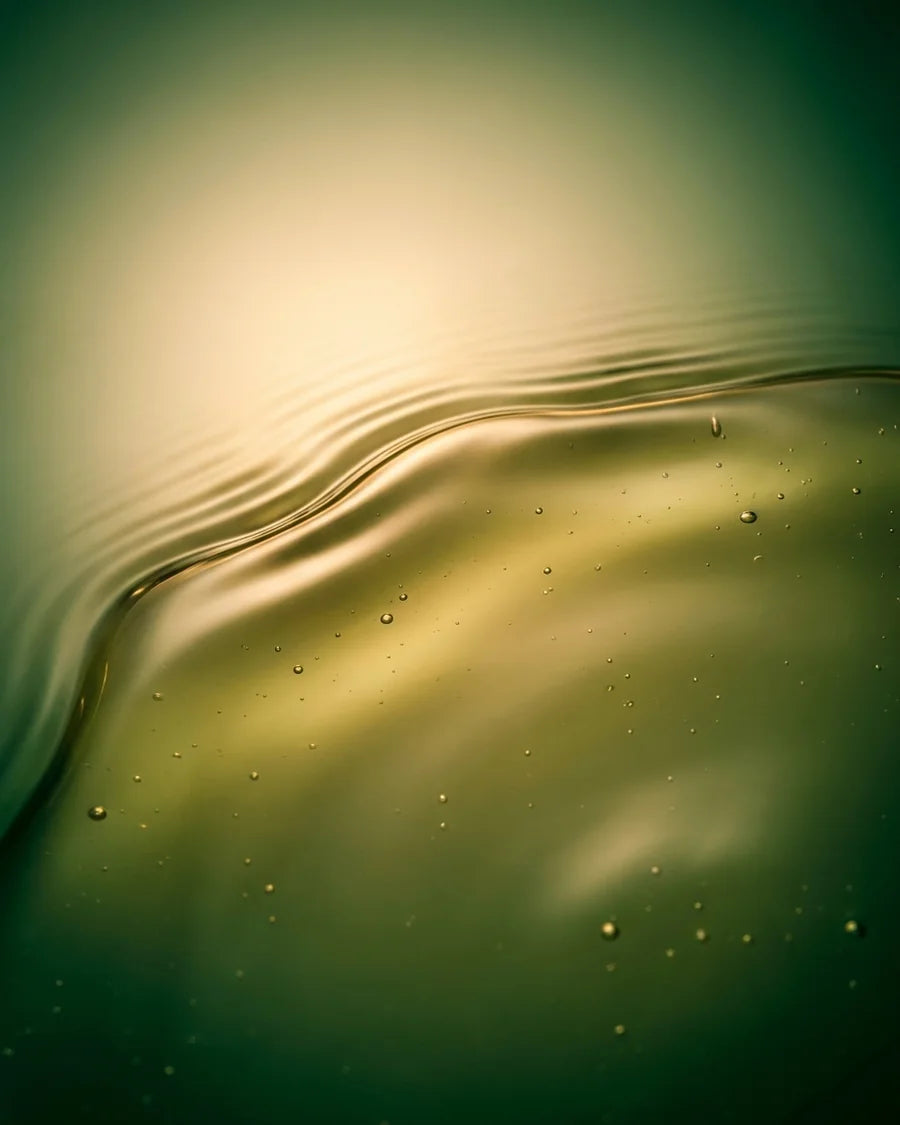 Honey-green Afghani Hair Oil on a glass dropper